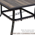 A close - up view of the lower part of an outdoor dining table with a brown - toned frame. The image highlights the firm leg connector design, which enhances the table's stability. The tabletop has a rustic wooden appearance. Outdoor Dining Table with Brown Frame: Sturdy Leg Connector Design. outdoor dining table, brown frame, firm leg connector, stable design, rustic tabletop.