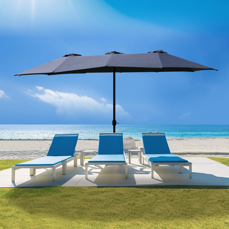 A navy blue Outdoor Patio Double - Sided Aluminum Umbrella stands on a patio area near a beach. Under the umbrella, there are three blue and white lounge chairs arranged, providing a comfortable spot for relaxation. The backdrop features a clear blue sky, the ocean, and sandy beach, highlighting the umbrella's suitability for outdoor leisure settings. Beige Outdoor Patio Double - Sided Aluminum Umbrella: Beachside Relaxation. beige outdoor umbrella, double - sided aluminum umbrella, patio umbrella, beach lo