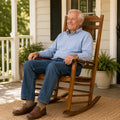 Senior woman relaxing with coffee on Kozyard white solid wood porch rocker, ergonomic garden rocking chair for lawn and deck.