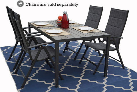 An outdoor dining setup with a rectangular composite wood dining table. The table is set with plates, napkins, a bowl of fruit, and a red carafe. Surrounding the table are six dark - colored folding chairs with fabric seats. Note: Chairs are sold separately. The table and chairs are placed on a blue patterned rug. Rectangular Outdoor Dining Table with Chairs (Sold Separately)rectangular dining table, composite wood table, outdoor dining set, folding chairs, sold separately.