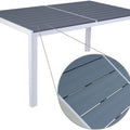 A rectangular outdoor dining table with a sleek white frame and a dark grey composite wood - like tabletop. The close - up detail highlights the textured slats of the tabletop, emphasizing its durable and stylish design.Rectangular Outdoor Dining Table with White Frame and Composite Wood Top. rectangular dining table, outdoor table, white frame, composite wood tabletop, textured slats