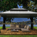 An outdoor hardtop gazebo with a sleek, metallic roof is set on a wooden deck in a picturesque natural setting. The gazebo features elegant, draped curtains and shelters a cozy lounge area with a sectional sofa, throw pillows, and a coffee table. The background showcases a serene lake, lush greenery, and distant mountains, creating a tranquil outdoor retreat. Tranquil Outdoor Gazebo: A Lakeside Retreat with Comfortable Seating. outdoor gazebo, lakeside gazebo, hardtop gazebo, comfortable seating.