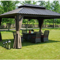 An outdoor hardtop gazebo with a dark - toned metal roof is set on a grassy lawn. The gazebo features earth - toned curtains that can be tied back, and underneath it, there is a wicker patio set with a table and chairs. Additionally, there are black lanterns placed on the grass nearby, enhancing the cozy outdoor ambiance.Cozy Outdoor Gazebo with Wicker Patio Set and Lanterns. outdoor gazebo, hardtop gazebo, wicker patio set, earth - toned curtains, black lanterns