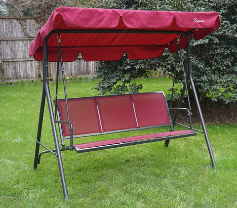 A red-colored outdoor swing chair set on a lush green lawn. The swing features a canopy of the same red hue, providing shade. The seating area is composed of red fabric panels, and a decorative patterned pillow adds a touch of style. The chair has a sturdy black metal frame, making it a cozy spot for relaxation in the garden. Red Outdoor Swing Chair for Garden Relaxation.
Red Outdoor Swing Chair for Garden Relaxation