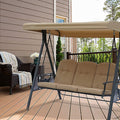 Tan Outdoor Swing Bench with Canopy on Deck
A tan outdoor swing bench with a matching canopy, set on a wooden deck. It features cushioned seating and a sturdy metal frame, accompanied by a wicker chair with a striped blanket and a small table with flowers in the background. Ideal for creating a cozy outdoor relaxation spot.
