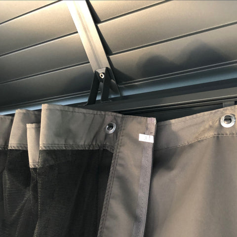 Gazebo Curtain Attachment Detail
A close - up of the attachment mechanism for gray curtains on an outdoor gazebo, showing grommets and a zipper on the fabric, with part of the gazebo's roof structure in the background. Keywords: gazebo curtains, attachment mechanism, grommets
