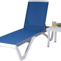 A vibrant outdoor lounge set featuring a blue - colored lounge bed with a breathable fabric surface, paired with a white side table holding two glasses of orange juice and some magazines.Blue Outdoor Lounge Bed with Matching Side Table. outdoor lounge bed, blue lounge bed, white side table, breathable fabric.
