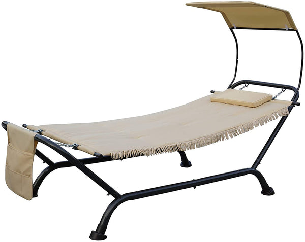 An outdoor hammock - style lounger with a beige fabric bed, a small cushion, and a canopy. It has a black metal frame and a side pocket, and the bottom edge of the fabric features a fringe design.Beige Outdoor Hammock Lounger with Canopy. outdoor hammock lounger, beige hammock, canopy - equipped hammock, metal - framed hammock.