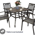 Title: Black Patio Dining Set with Geometric Backrests
Alt Text: Four black patio chairs with geometric backrests around a table, decorated with flowers and cups, with text "Table is not included."
Keywords: black patio dining set, geometric backrest, outdoor furniture, modern design, garden seating, floral decor, table not included

