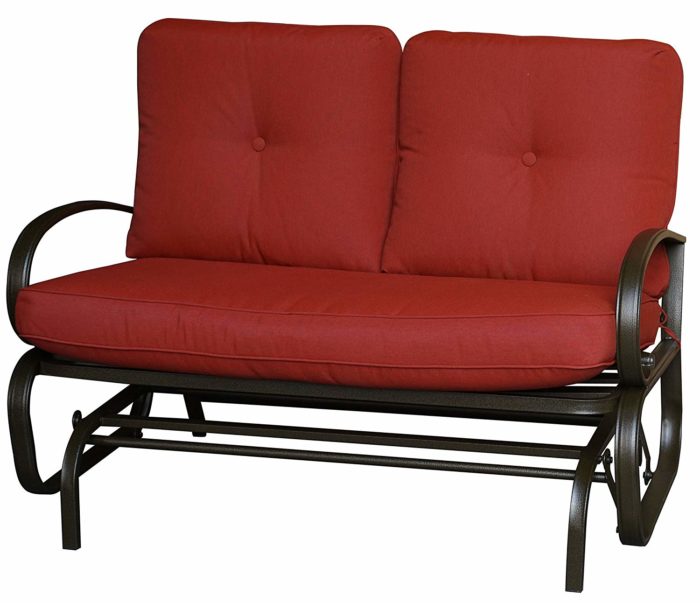 A glider chair with a red cushioned seat and backrest. The chair features a sturdy metal frame with curved armrests and a slatted lower frame, designed for comfortable outdoor or indoor relaxation. glider chair, red cushion, metal frame, curved armrests, relaxation.