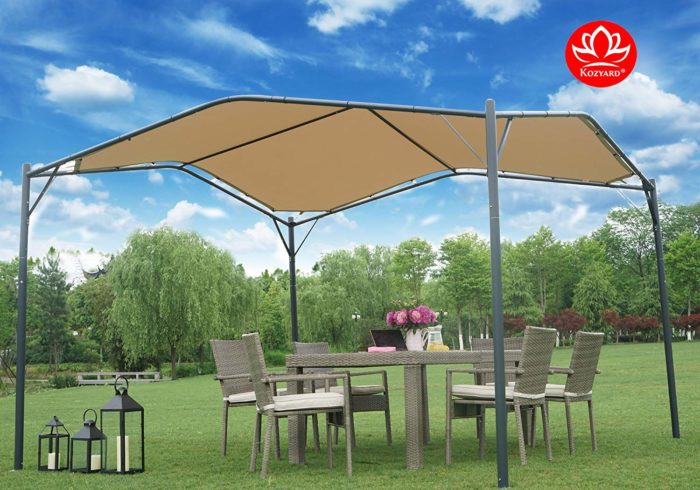 A KOZYARD Sun Shade Gazebo with a tan canopy is set on a lush green lawn. Beneath the gazebo, there is an outdoor wicker dining set with chairs and a table adorned with a vase of pink flowers. Lanterns are placed on the grass nearby, adding to the cozy outdoor ambiance.KOZYARD Sun Shade Gazebo: Ideal for Outdoor Relaxation.KOZYARD sun shade gazebo, tan canopy, outdoor wicker furniture, outdoor relaxation, garden lanterns.
