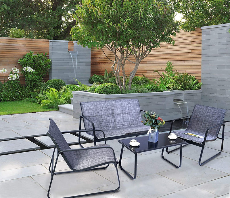 Outdoor Patio Furniture Set in Garden
An outdoor patio furniture set with two chairs, a loveseat, and a glass - topped coffee table, placed in a garden with plants, trees, and a water feature in the background. Keywords: outdoor furniture set, patio seating, garden setting