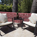 Charming Outdoor Rocking Chair Set
alt text：A pair of outdoor rocking chairs with white cushions and chevron - patterned pillows, accompanied by a small table with a potted plant, set against a red brick wall with greenery in the background. Keywords: outdoor rocking chairs, patio set, brick wall decor