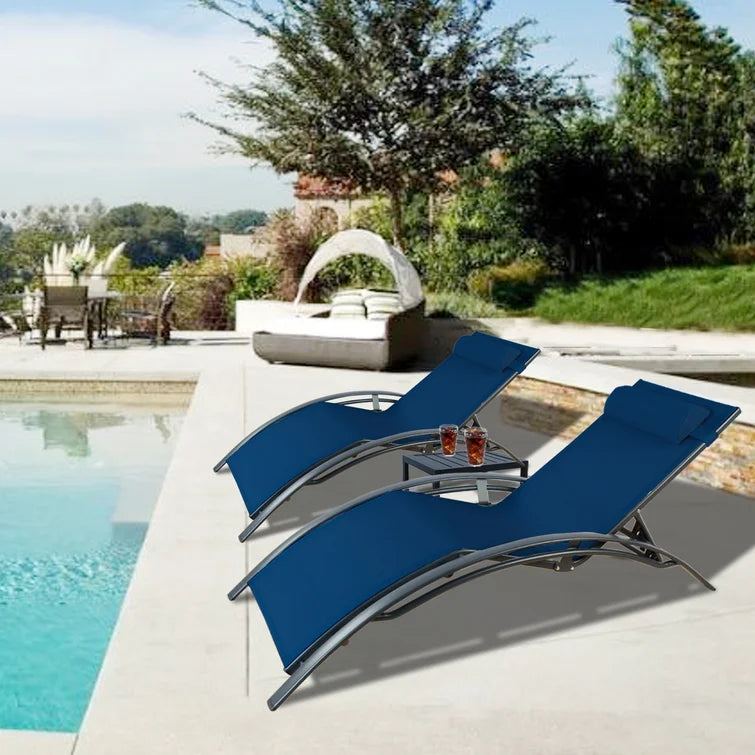 Serene Blue Poolside Lounge Chair Set
alt text：A pair of blue lounge chairs with headrests beside a pool, featuring a small side table with drinks, set against a backdrop of greenery and outdoor decor. Keywords: blue lounge chairs, poolside, outdoor relaxation