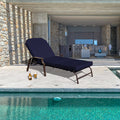 Elegant Navy Blue Outdoor Lounge Chair
alt text：A navy blue outdoor lounge chair placed by a pool, with a bottle and glass of beer beside it, and a modern indoor living space in the background. Keywords: outdoor lounge chair, navy blue, poolside
