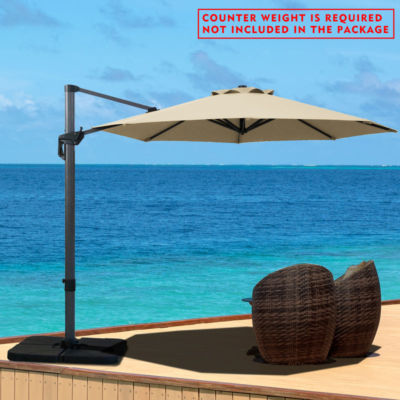 A beige cantilever patio umbrella set up on a wooden deck overlooking the ocean. Note: Counter weight is required and not included in the package.
Outdoor offset umbrella providing shade near wicker chairs by the seaside. Counter weight needed, not part of the package. Seaside Cantilever Umbrella: Counter Weight Not Included. Ocean - View Patio Umbrella: Counter Weight Required. cantilever umbrella, patio umbrella, outdoor umbrella, seaside umbrella, counter weight, wicker chairs, ocean - view