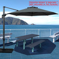 Gray cantilever patio umbrella providing shade over a picnic table by the seaside. Note: Counter weight is required and not included in the package. Outdoor offset umbrella in a coastal setting. It shades an outdoor table, and a counter weight is needed but not part of the package. Seaside Patio Umbrella: Counter Weight Not Included. Cantilever Umbrella for Outdoor Use: Counter Weight Required. cantilever umbrella, patio umbrella, outdoor umbrella, counter weight, umbrella shade