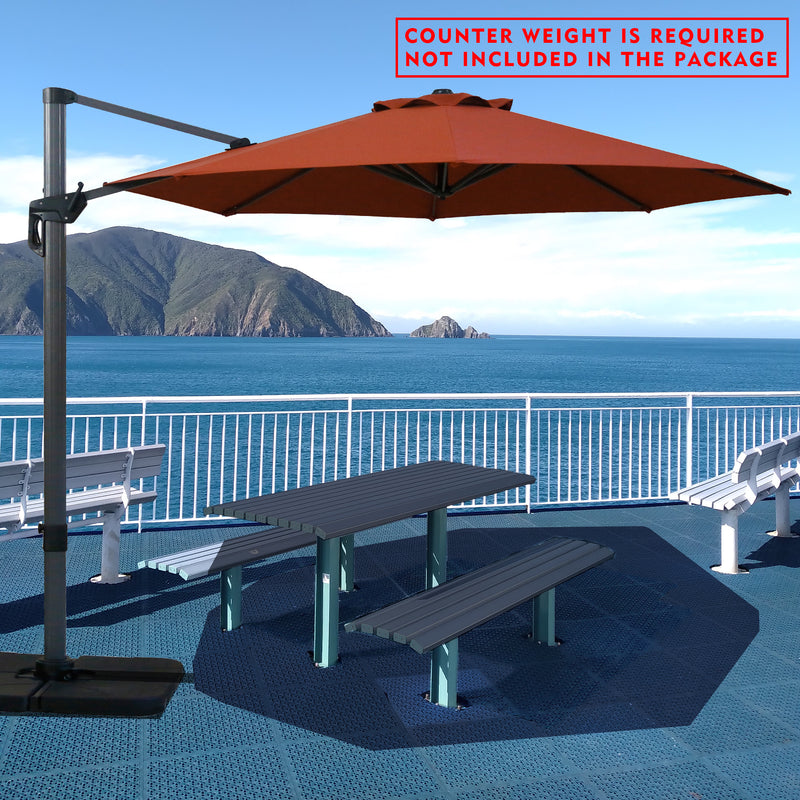 Red cantilever patio umbrella providing shade over a picnic table by the seaside. Note: Counter weight is required and not included in the package. Outdoor offset umbrella in a coastal setting. It shades an outdoor table, and a counter weight is needed but not part of the package. Seaside Patio Umbrella: Counter Weight Not Included. Cantilever Umbrella for Outdoor Use: Counter Weight Required. cantilever umbrella, patio umbrella, outdoor umbrella, counter weight, umbrella shade