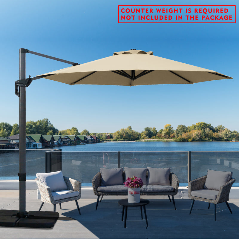 A beige cantilever patio umbrella set up on a wooden deck overlooking the lake. Note: Counter weight is required and not included in the package.
Outdoor offset umbrella providing shade near wicker chairs by the lake side. Counter weight needed, not part of the package. Lake side Cantilever Umbrella: Counter Weight Not Included. Ocean - View Patio Umbrella: Counter Weight Required. cantilever umbrella, patio umbrella, outdoor umbrella, seaside umbrella, counter weight, wicker chairs, lake - view