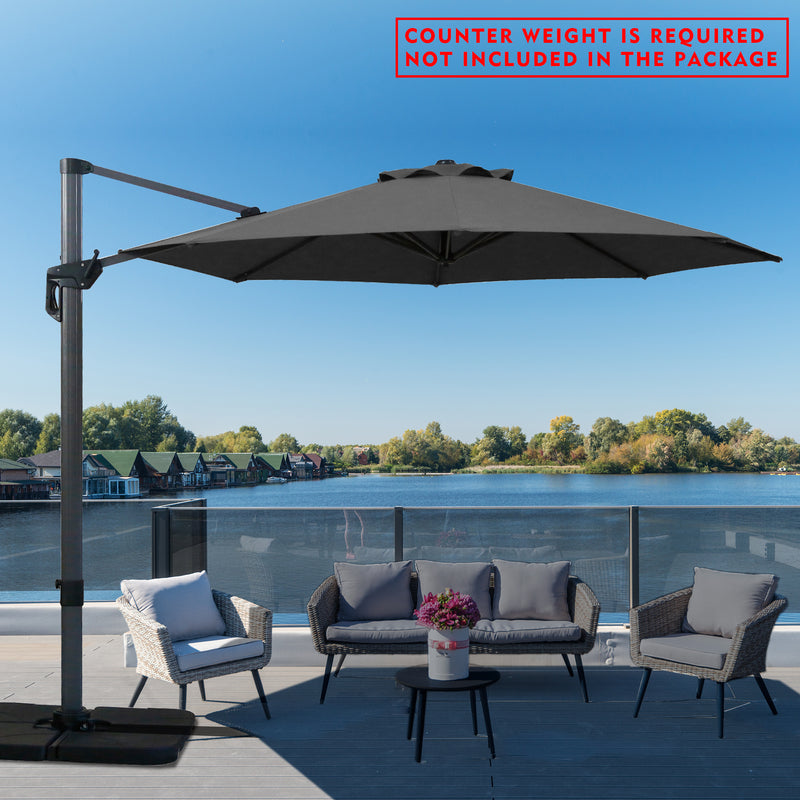 A gray cantilever patio umbrella set up on a wooden deck overlooking the lake. Note: Counter weight is required and not included in the package.
Outdoor offset umbrella providing shade near wicker chairs by the lake side. Counter weight needed, not part of the package. Lake side Cantilever Umbrella: Counter Weight Not Included. Ocean - View Patio Umbrella: Counter Weight Required. cantilever umbrella, patio umbrella, outdoor umbrella, seaside umbrella, counter weight, wicker chairs, lake - view