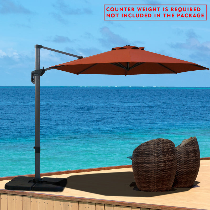 A red cantilever patio umbrella set up on a wooden deck overlooking the ocean. Note: Counter weight is required and not included in the package.
Outdoor offset umbrella providing shade near wicker chairs by the seaside. Counter weight needed, not part of the package. Seaside Cantilever Umbrella: Counter Weight Not Included. Ocean - View Patio Umbrella: Counter Weight Required. cantilever umbrella, patio umbrella, outdoor umbrella, seaside umbrella, counter weight, wicker chairs, ocean - view