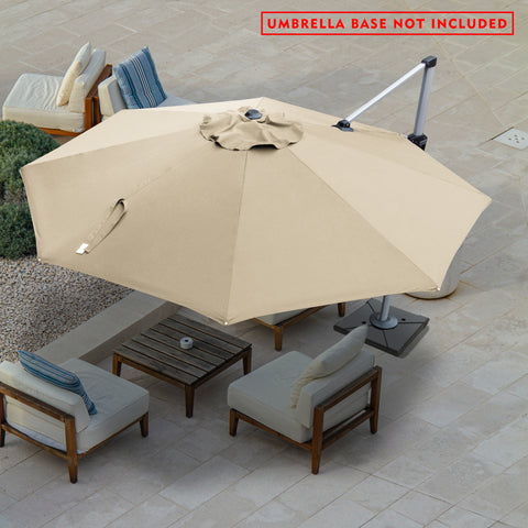 A beige - colored cantilever patio umbrella provides shade over an outdoor seating area. The umbrella is open, with a fabric cover on the top center. The setup includes a wooden coffee table and cushioned chairs with blue - striped and plain pillows. A red notice at the top states "UMBRELLA BASE NOT INCLUDED". The scene is set on a tiled patio with some greenery in the background.cantilever patio umbrella, offset umbrella, beige umbrella, umbrella base not included, outdoor seating, patio umbrella.