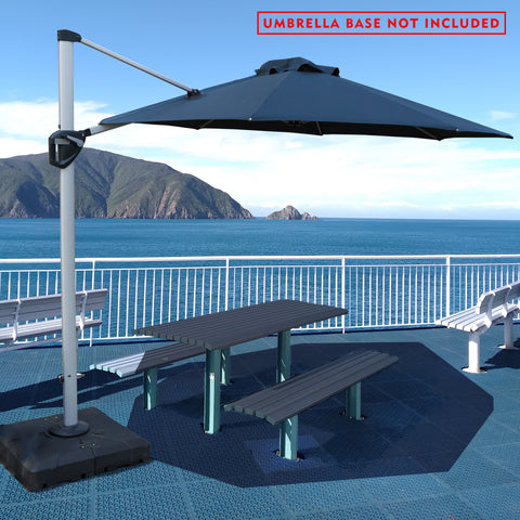 A stylish outdoor offset umbrella in navy blue provides shade over a picnic table on a deck with a stunning ocean and mountain backdrop. The umbrella is mounted on a base, but a notice in red text states "UMBRELLA BASE NOT INCLUDED". The deck has additional white benches, and the overall setting is bright and inviting.
Navy Blue Cantilever Patio Umbrella: Scenic Outdoor Shade, Base Not Included
Outdoor Offset Umbrella: Enjoy the View, Base Not Included.
cantilever patio umbrella, offset umbrella, navy blue 