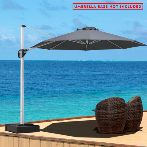 A gray - colored cantilever patio umbrella stands on a wooden deck overlooking a stunning blue ocean. The umbrella is positioned to provide shade over a pair of wicker chairs. A red notice at the top states "UMBRELLA BASE NOT INCLUDED". The serene seascape in the background enhances the relaxing outdoor setting.Gray Cantilever Patio Umbrella by the Sea: Base Not Included.cantilever patio umbrella, offset umbrella, gray umbrella, umbrella base not included, seaside patio, wicker chairs.