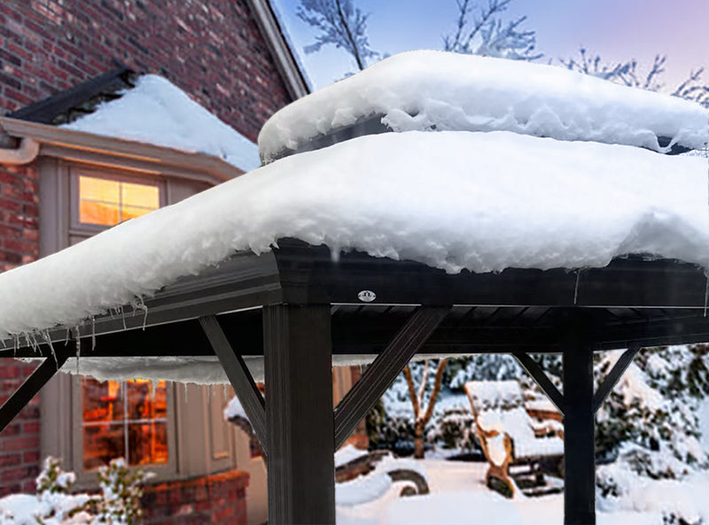 An outdoor gazebo with a dark - colored frame is blanketed in a thick layer of snow. Icicles hang from the edge of the roof, indicating a cold winter setting. In the background, there is a brick house with a lit window, and snow - covered trees and furniture, enhancing the wintry atmosphere. Outdoor Gazebo in Winter: Snow - Covered Serenity. outdoor gazebo, winter scene, snow - covered, icicles, winter atmosphere