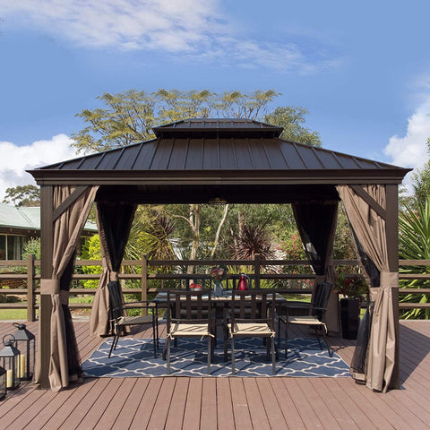 A charming outdoor gazebo with a dark brown metal roof and wooden - toned frame stands on a wooden deck. Beige curtains are tied back around the gazebo, which houses an outdoor dining setup with a table, chairs, and a decorative blue - and - white rug. The background features lush greenery and a clear blue sky with scattered clouds. Inviting Outdoor Gazebo for Relaxation and Dining. outdoor gazebo, metal roof, wooden frame, beige curtains, outdoor dining area.