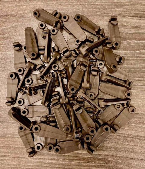 Bulk Brown Plastic Hooks for gazebo curtain– Durable Hardware for Fence and Gate Latches. A large pile of brown plastic hooks, designed for fencing, gates, and latch systems. Weather-resistant and durable for outdoor use.