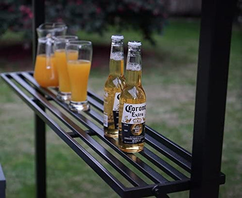 On the black metal shelf of an outdoor barbecue gazebo, there are two bottles of Corona Extra beer and several glasses filled with orange juice. The setting suggests a casual and refreshing outdoor gathering. Refreshments on the Shelf of an Outdoor Barbecue Gazebo. outdoor barbecue gazebo, black metal shelf, Corona Extra beer, orange juice, outdoor gathering