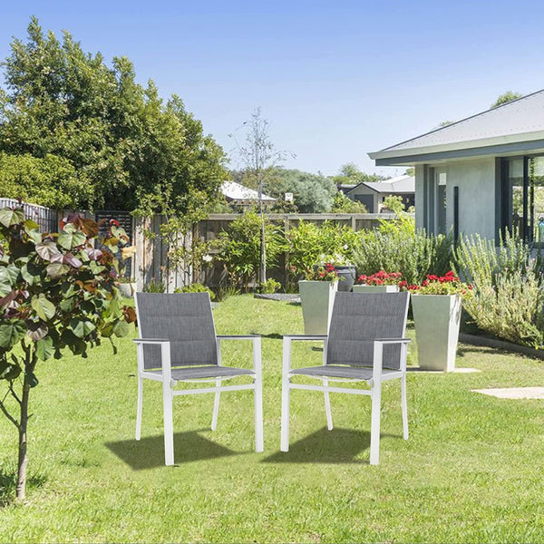 Outdoor Patio Chairs in a Garden Setting
Two outdoor patio chairs with gray fabric and white frames placed on a grassy lawn, surrounded by plants and a house in the background. Keywords: outdoor chairs, patio furniture, garden setting
