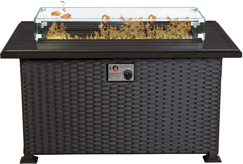 A rectangular outdoor wicker fire pit table with a glass wind - guard surrounding the flame area. The table top is dark - colored, and there is a control panel with a knob and a red button on the front, likely for igniting and adjusting the flame.Stylish Wicker Outdoor Fire Pit Table. outdoor fire pit table, wicker fire pit, glass - enclosed flame, fire pit control panel, patio heating.