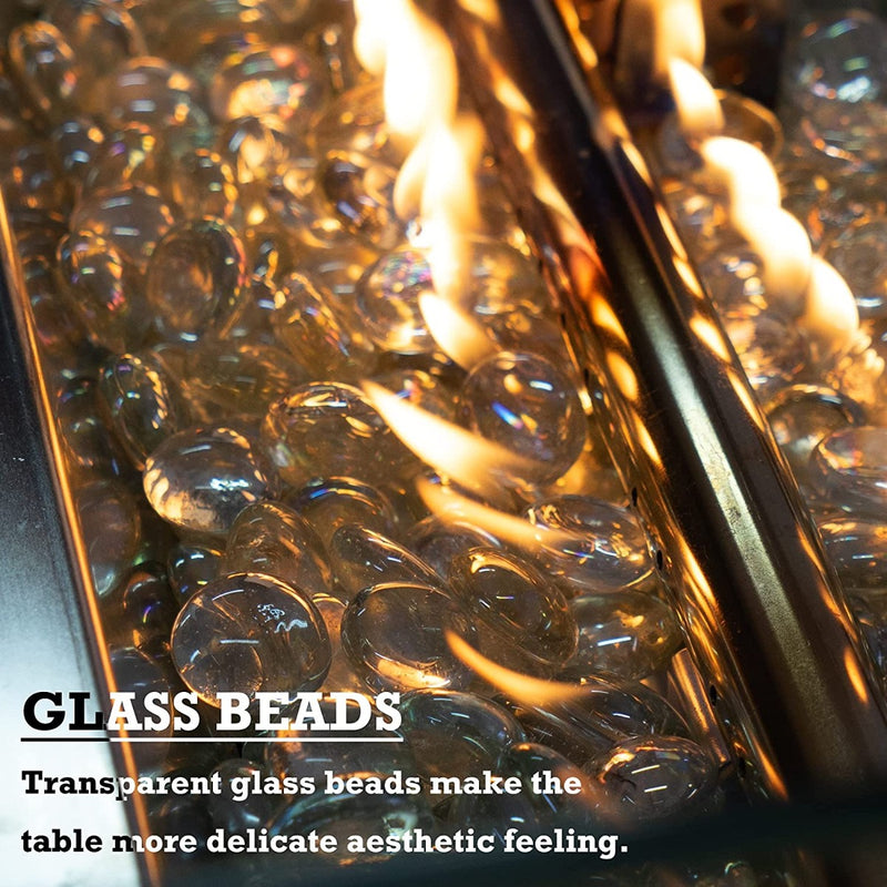 A close - up view of a fire pit table filled with transparent glass beads, through which flames are flickering. The text "GLASS BEADS" and "Transparent glass beads make the table more delicate aesthetic feeling" emphasizes the aesthetic appeal of the glass beads in the fire pit.Fire Pit Table with Aesthetic Glass Beads.fire pit table, glass beads, transparent fire pit decor, aesthetic patio furniture, outdoor fire feature