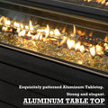 A close - up view of the flame area of an outdoor fire pit table, showcasing golden - hued glass beads amidst the flames. The text below highlights that the tabletop is made of exquisitely patterned aluminum, emphasizing its strength and elegance. Elegant Aluminum - Topped Outdoor Fire Pit Table . outdoor fire pit table, aluminum tabletop, glass beads fire pit, elegant patio furniture, strong fire pit
