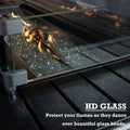 A close - up of the fire pit area of an outdoor fire pit table, showing clear glass beads illuminated by dancing flames. The flames are surrounded by a high - definition (HD) glass barrier. The text "HD GLASS" and "Protect your flames as they dance over beautiful glass beads" emphasizes the protective function of the glass. Outdoor Fire Pit Table with HD Glass Protection. outdoor fire pit table, HD glass barrier, glass beads fire pit, flame protection, patio fire feature
