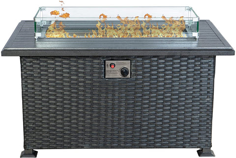 A rectangular outdoor wicker fire pit table with a glass wind - guard surrounding the flame area. The table top is dark - colored, and there is a control panel with a knob and a red button on the front, likely for igniting and adjusting the flame.Stylish Wicker Outdoor Fire Pit Table. outdoor fire pit table, wicker fire pit, glass - enclosed flame, fire pit control panel, patio heating.