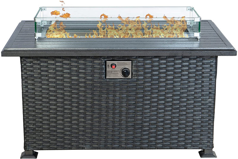 A rectangular outdoor wicker fire pit table with a glass wind - guard surrounding the flame area. The table top is dark - colored, and there is a control panel with a knob and a red button on the front, likely for igniting and adjusting the flame.Stylish Wicker Outdoor Fire Pit Table. outdoor fire pit table, wicker fire pit, glass - enclosed flame, fire pit control panel, patio heating.