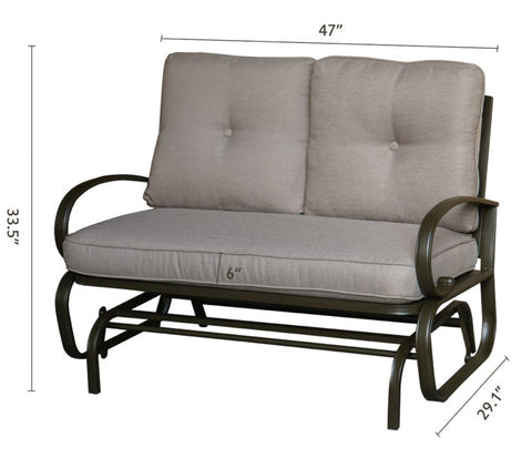 A glider chair with beige cushions, featuring dimensions of 47 inches in width, 33.5 inches in height, and a seat cushion thickness of 6 inches. The chair has a sturdy metal frame with curved arm - rests, and a height of 29.1 inches from the ground to the bottom of the frame. Beige - Cushioned Glider Chair with Dimensions. beige - cushioned glider chair, metal - framed glider, cushioned seating, chair dimensions.