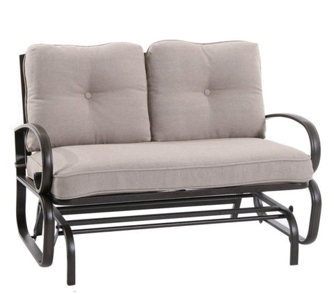 A glider chair with a beige cushioned seat and backrest. The chair features a sturdy metal frame with curved armrests and a slatted lower frame, designed for comfortable outdoor or indoor relaxation.Beige - Cushioned Glider Chair for Relaxing. glider chair, beige cushion, metal frame, curved armrests, relaxation.