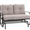 A glider chair with a beige cushioned seat and backrest. The chair features a sturdy metal frame with curved armrests and a slatted lower frame, designed for comfortable outdoor or indoor relaxation.Beige - Cushioned Glider Chair for Relaxing. glider chair, beige cushion, metal frame, curved armrests, relaxation.
