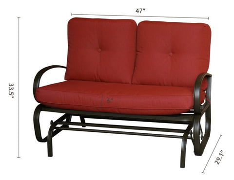 A glider chair with red cushions, featuring dimensions of 47 inches in width, 33.5 inches in height, and a seat cushion thickness of 6 inches. The chair has a sturdy metal frame with curved arm-rests, and a height of 29.1 inches from the ground to the bottom of the frame. red-cushioned glider chair, metal-framed glider, cushioned seating, chair dimensions.